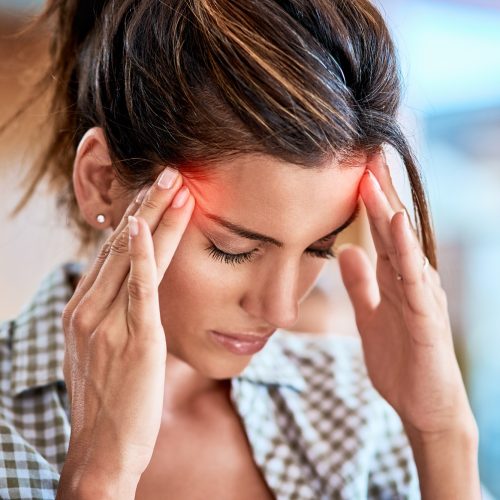 I have to keep away from focusing on the pain Shot of a uncomfortable looking woman holding her head in discomfort due to pain at home during the day